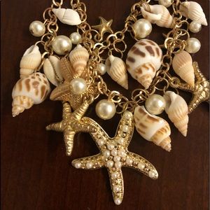 Shell, dual strand gold and pearl necklace.